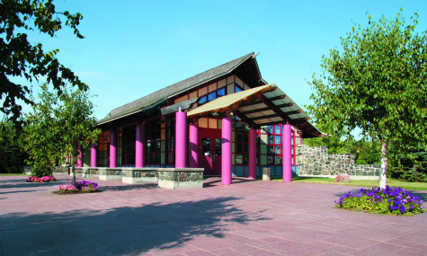 information centre with bright pink pillars and wooden building